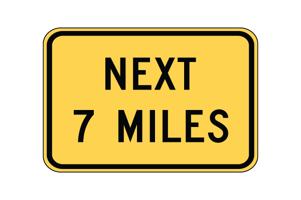 Yellow rectangular sign with black text that reads "X number miles ahead"