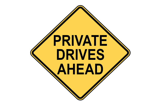Yellow diagonal sign with black text that reads "Private drives ahead"