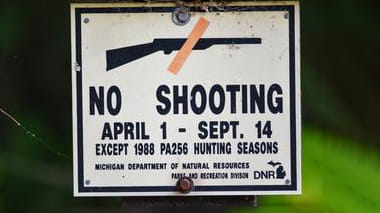 A sign that says no shooting from April 1 through September 14.