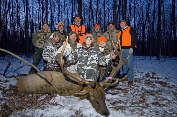 Boy who won the Pure Michigan Hunt poses with elk. 