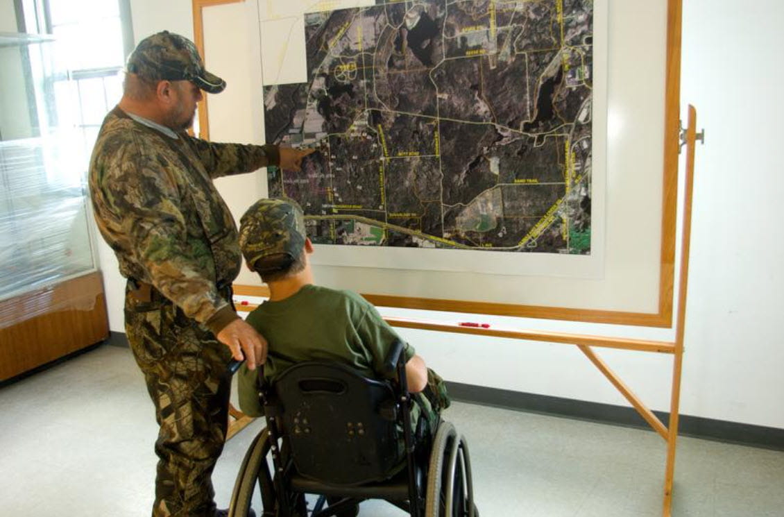 Two hunters look at a map