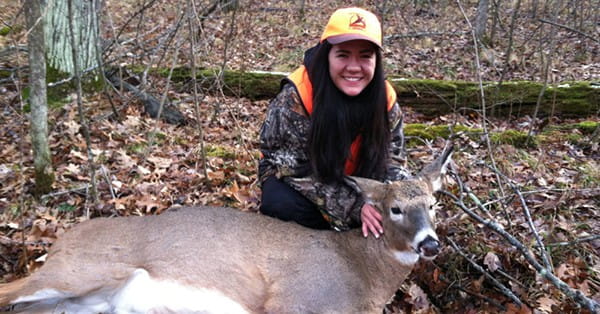 Photo of a girl with a harvested deer.