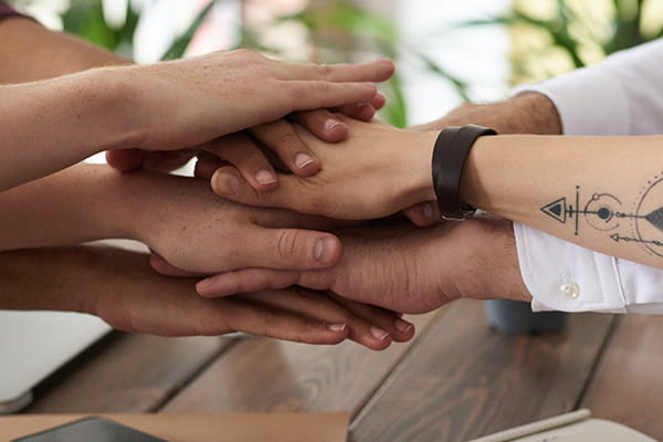 hands overlapping over table