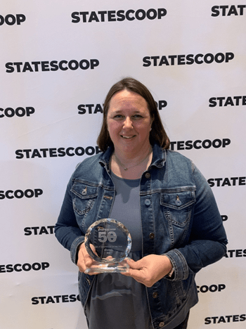 Photo of Laura Clark holding award.