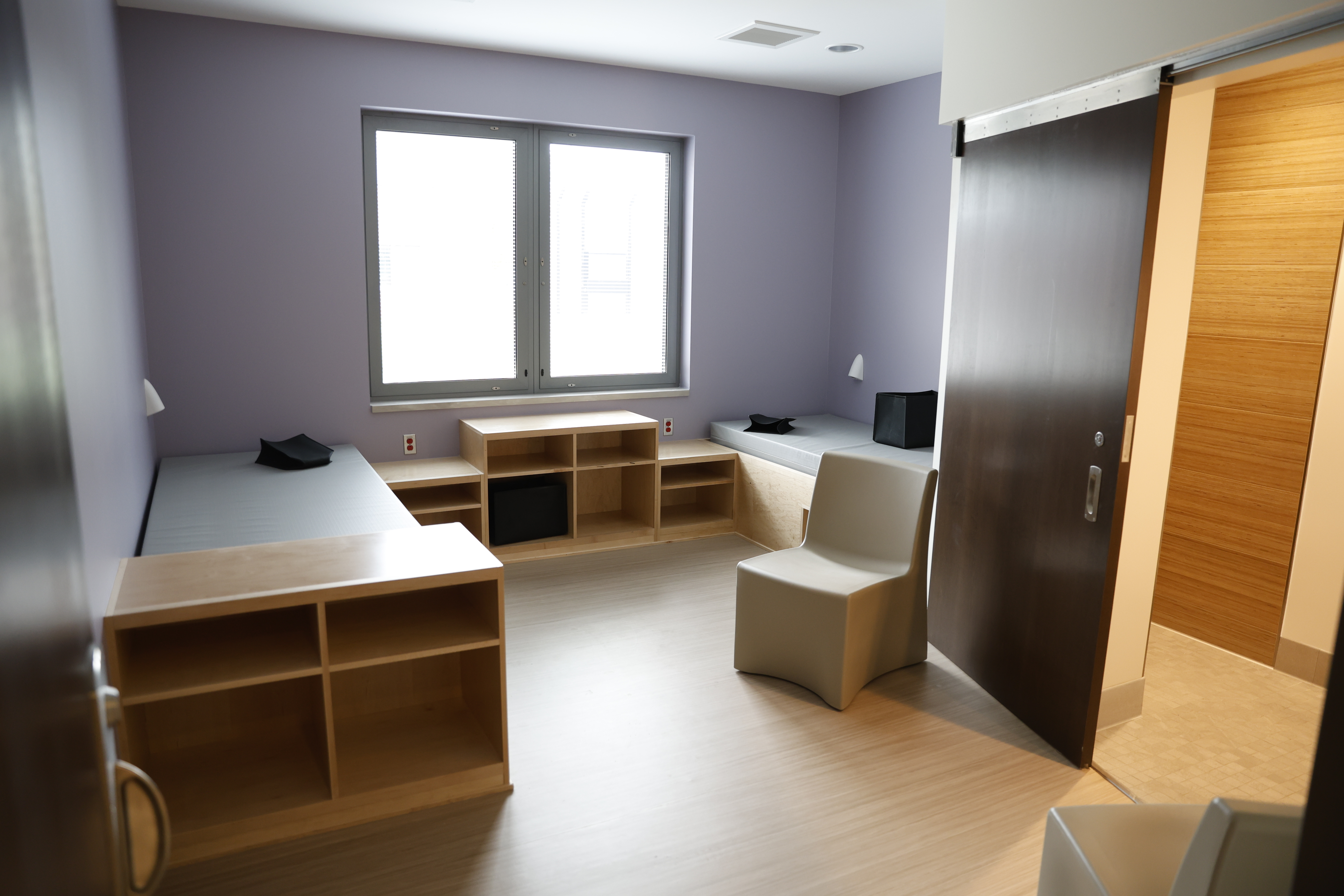 Photo in the Caro Psychiatric Hospital. Photo is taken in a room, features a bed.