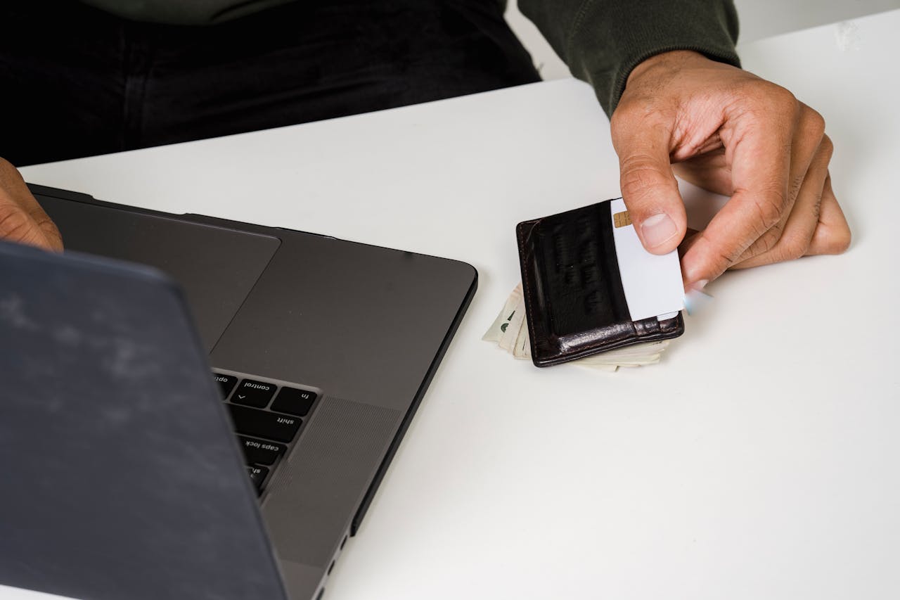 Open laptop with credit card nearby.