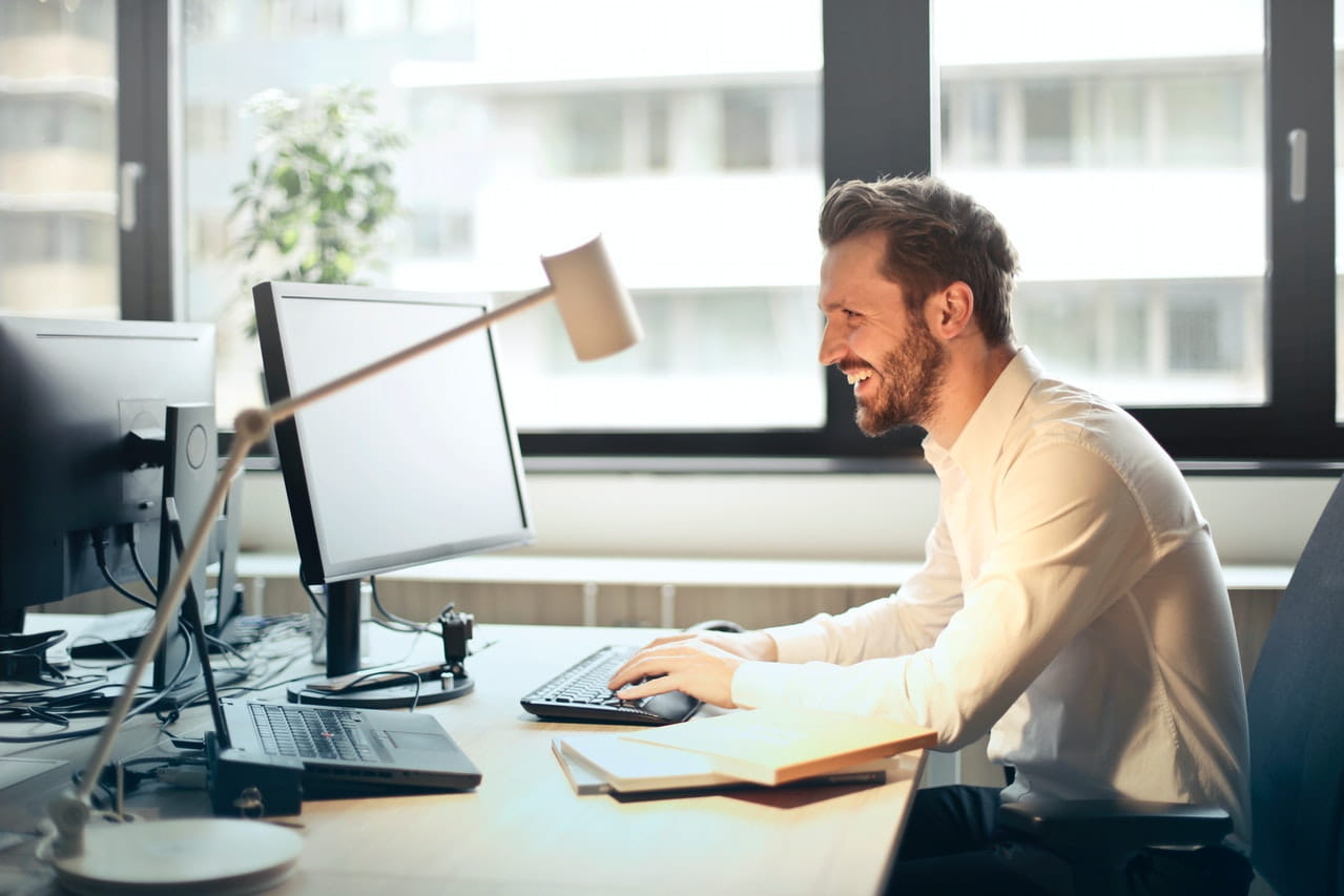 Man on working on computer at desk.