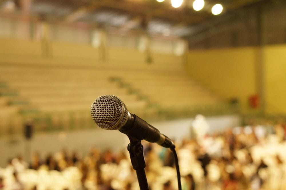 A microphone standing in an auditorium