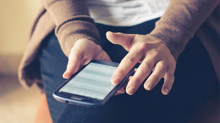 a closeup of a person holding a smartphone