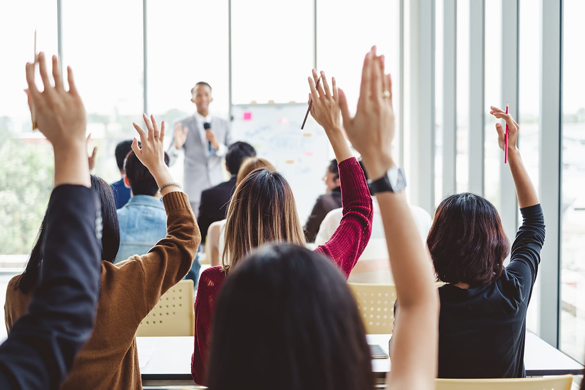 public input photo with hands up in a meeting room