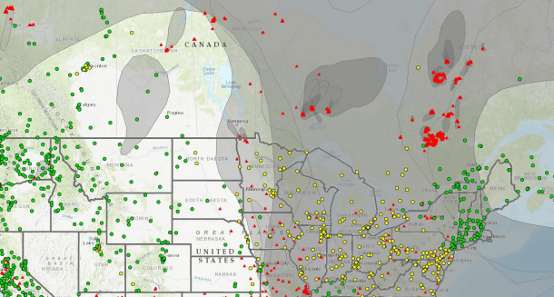 A map of the midwest and Canada, with yellow and red points indicating wildfires scattered across the lands