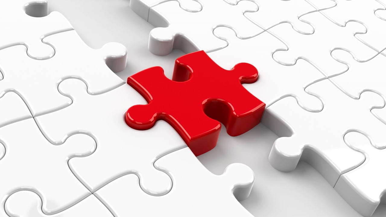 a puzzle piece connects two larger puzzles on either side