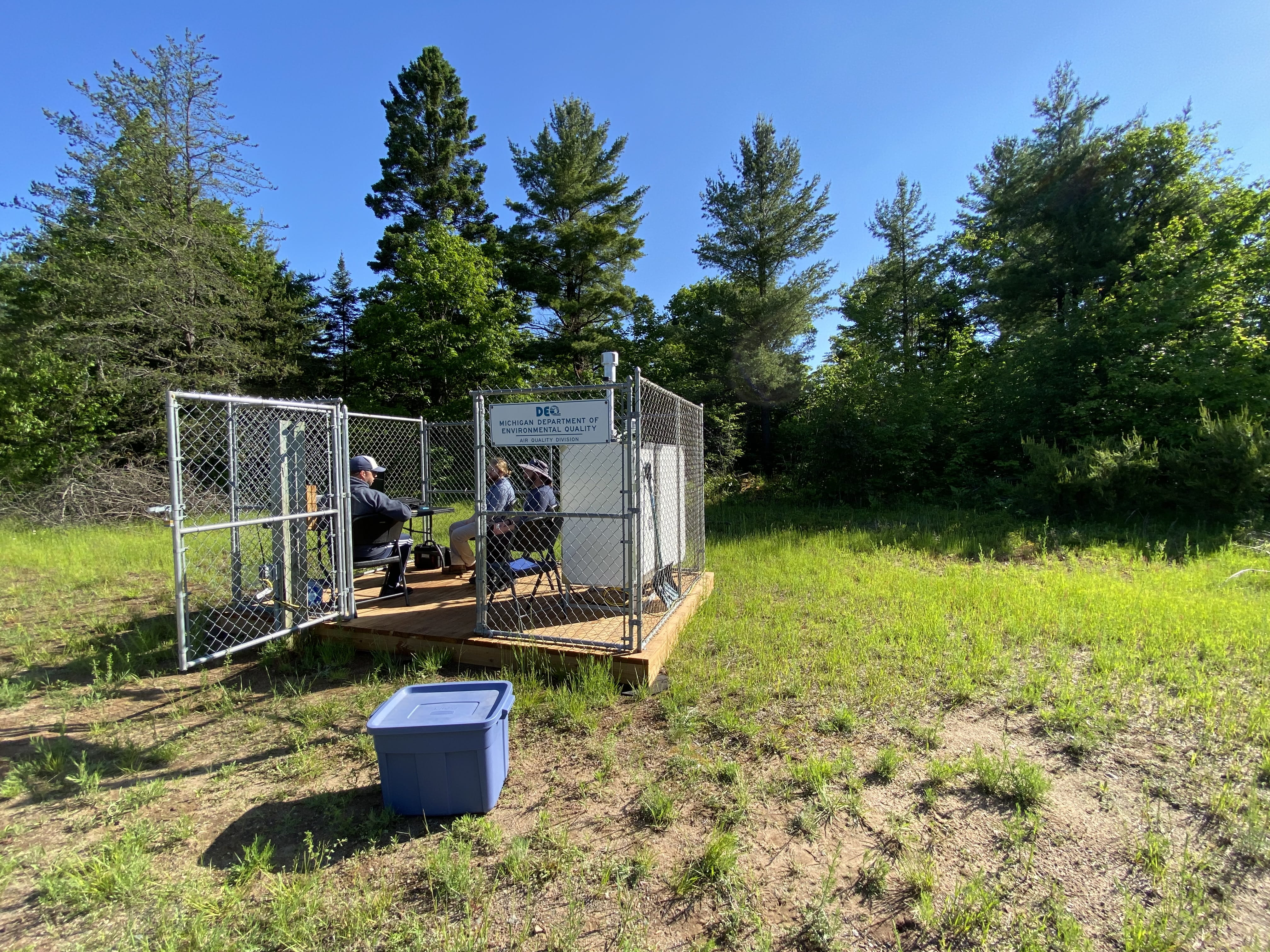 The air monitor sits nestled in a grove of trees on a remote parcel in Negaunee Township.