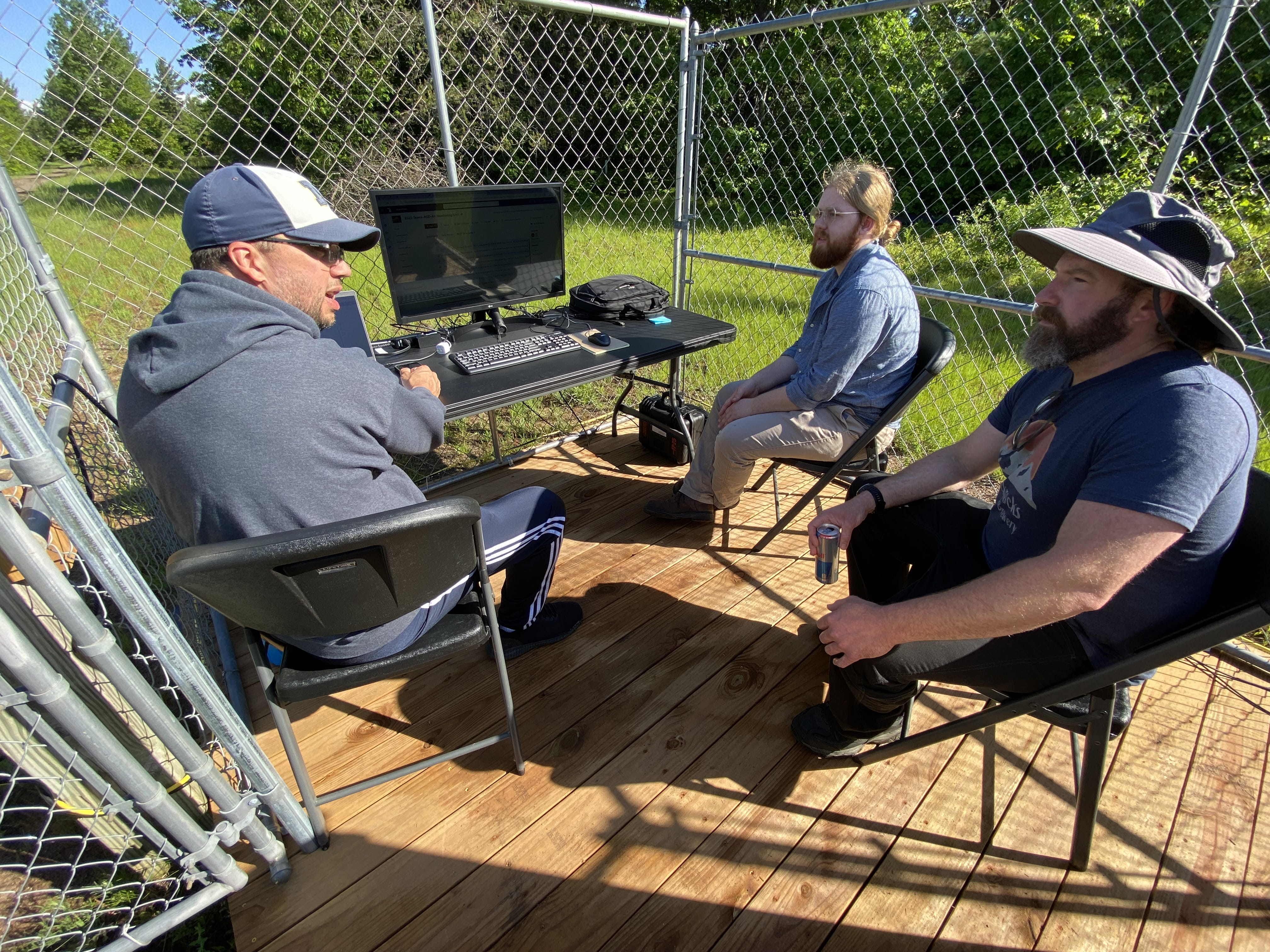 EGLE environmental technician Brian Lomerson, left, explains the air monitoring system to Drew Yesmunt and Joe Scanlan, both of whom will oversee the site.