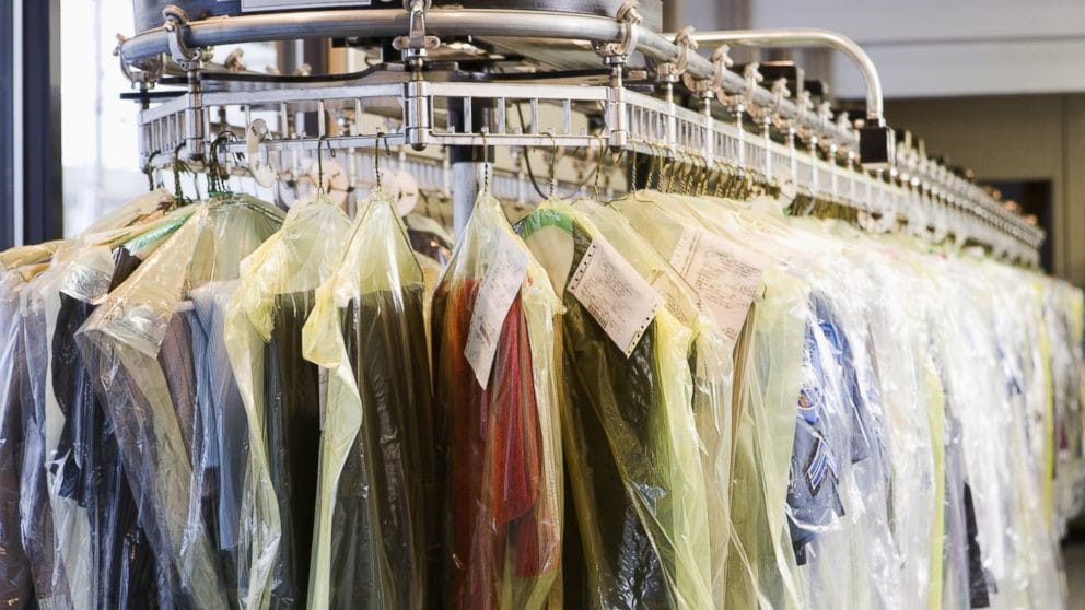 dry cleaned clothing hanging on a conveyor belt