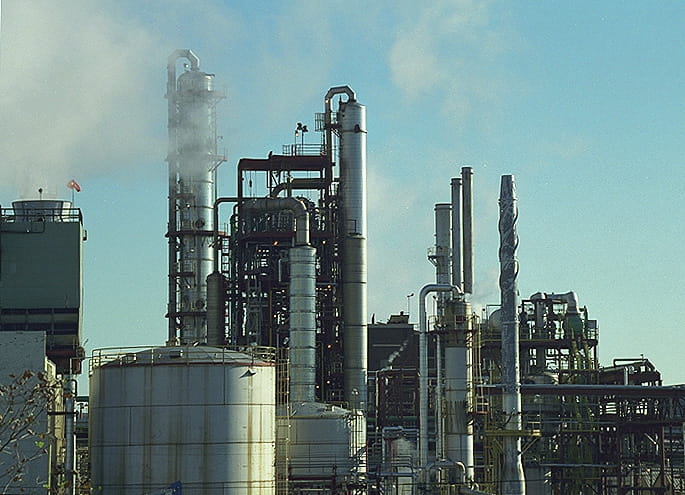 Picture of a factory with smoke stacks