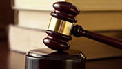 a gavel hitting a wooden pedestal