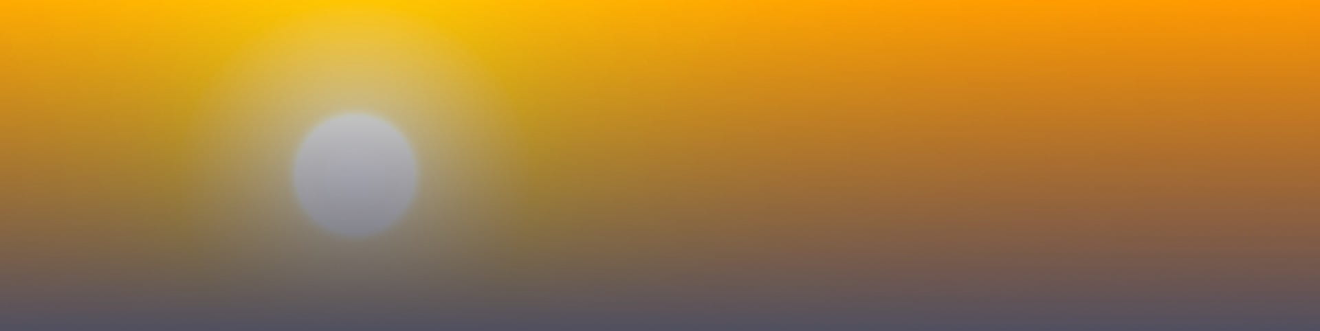 The sun high in a hazy sky.