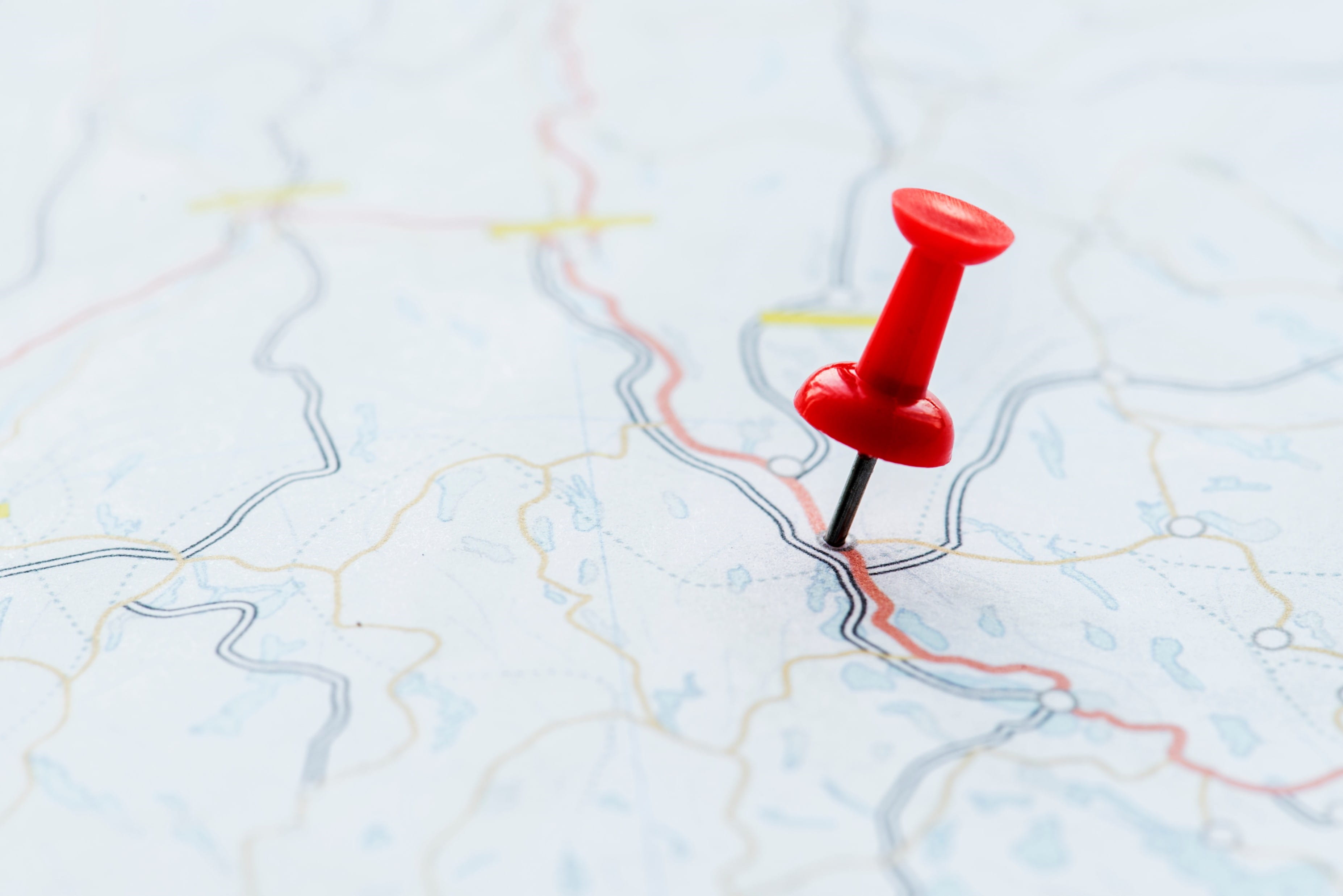 A thumbtack placed on a map