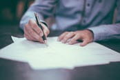 Close up of a man writing a permit
