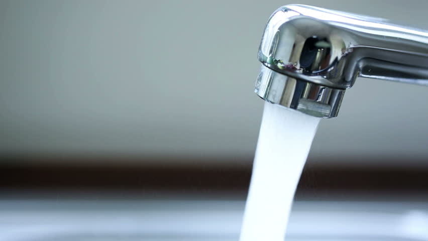 Water running out of a faucet.
