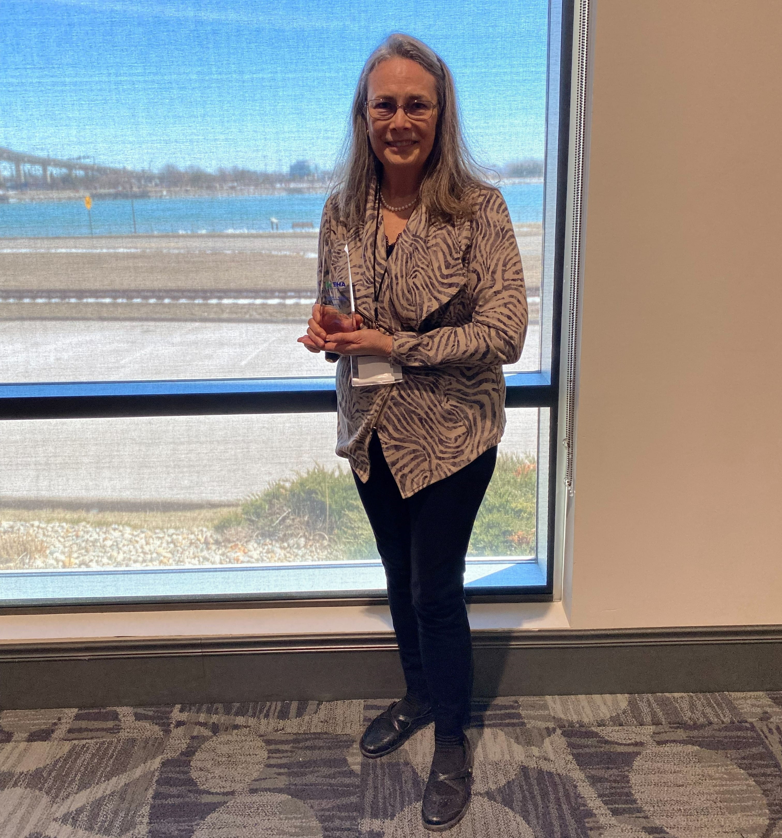 Lois Graham, senior PFAS analyst, hold the LaRue Miller Lifetime Achievement award, which she received from the Michigan Environmental Health award.