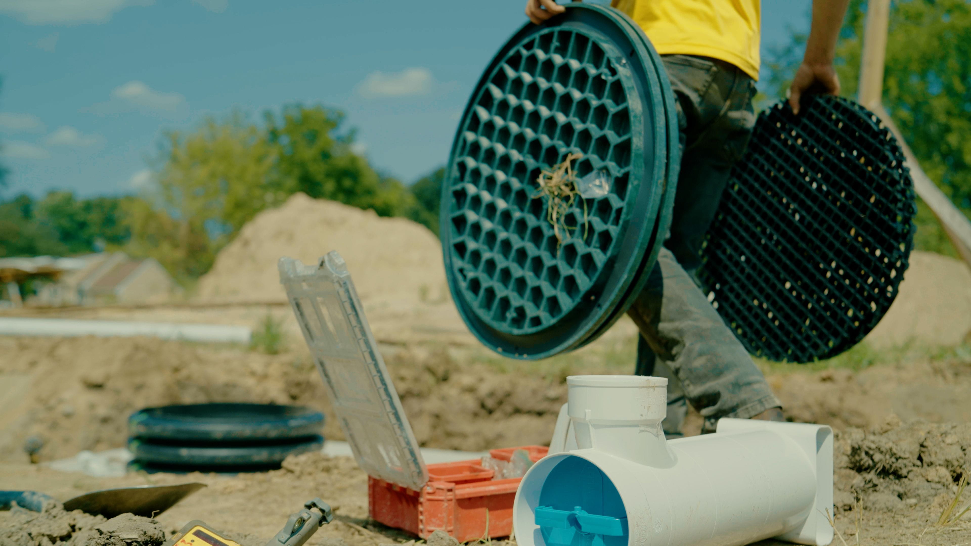 Septic system being replaced with contractor carrying equipment