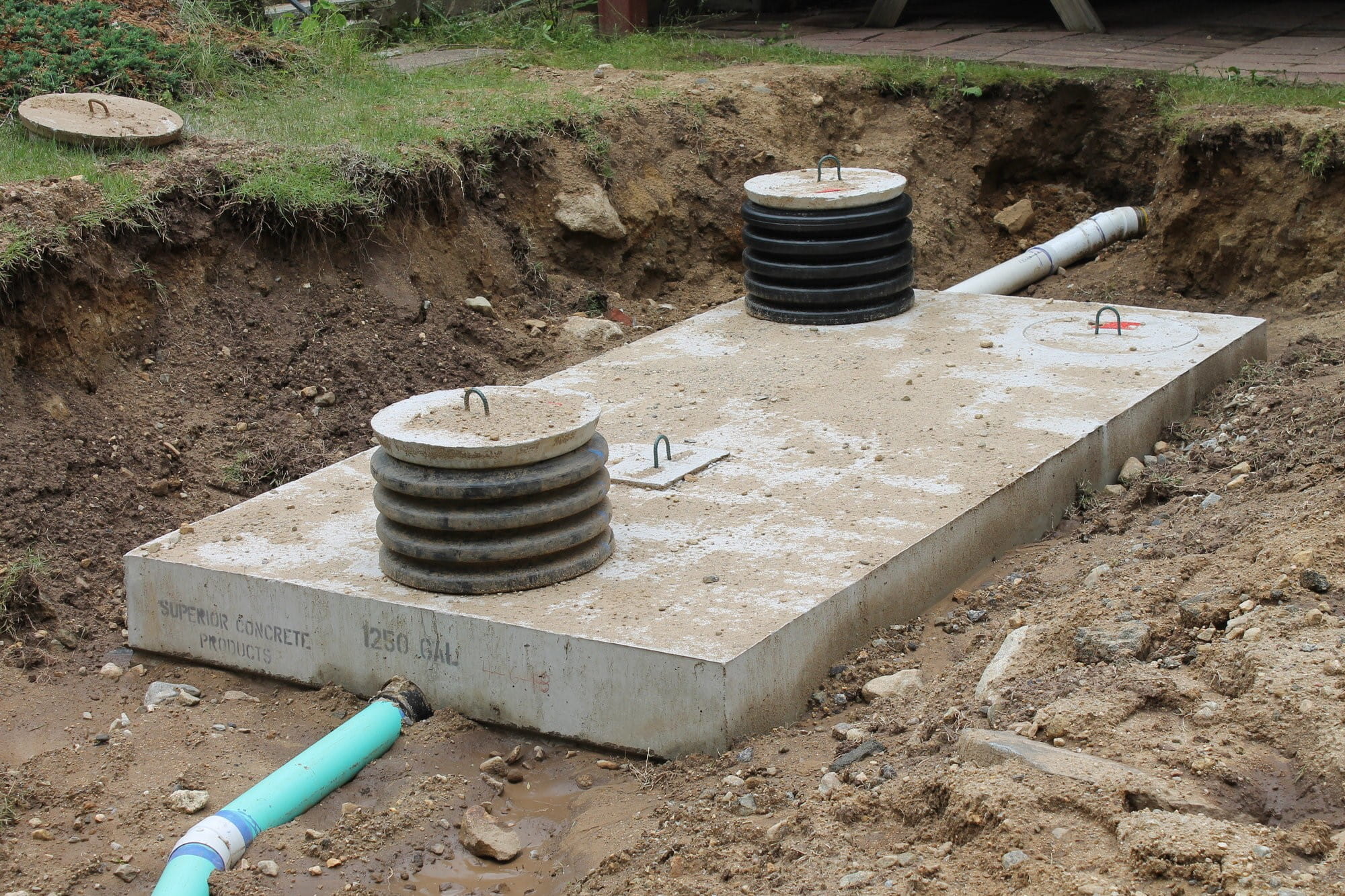 A two-compartment concrete septic tank.