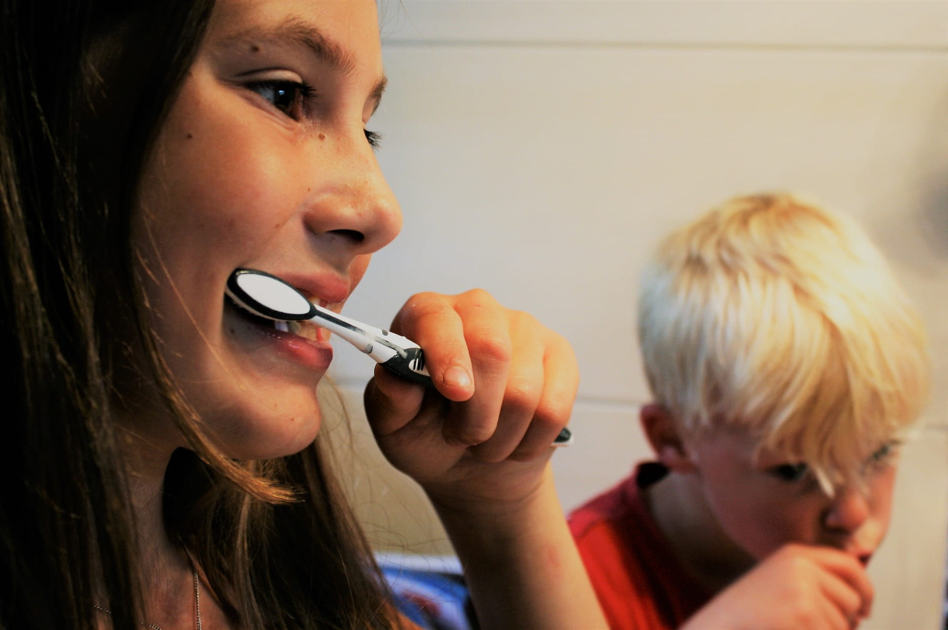 two kids brushing their teeth