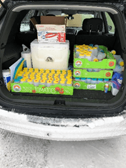 bottles of samples in trunk of car
