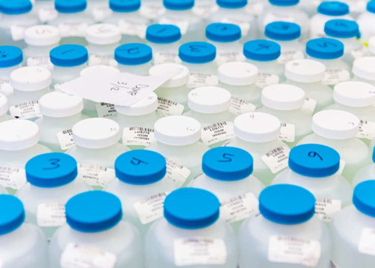 several white and blue sampling bottles