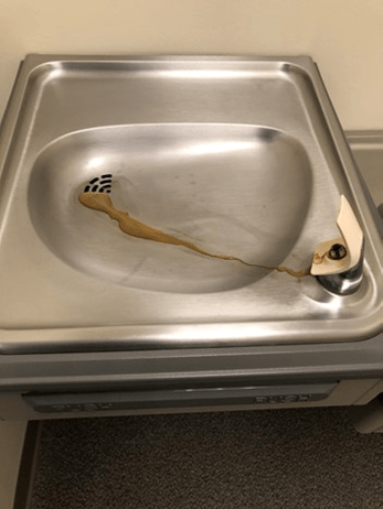 school drinking fountain with dirty water