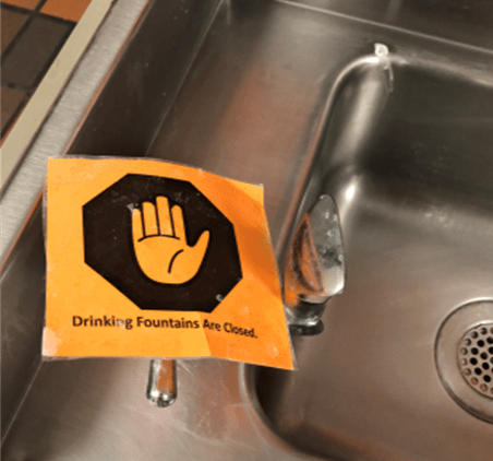 sink with drinking fountains are closed sign