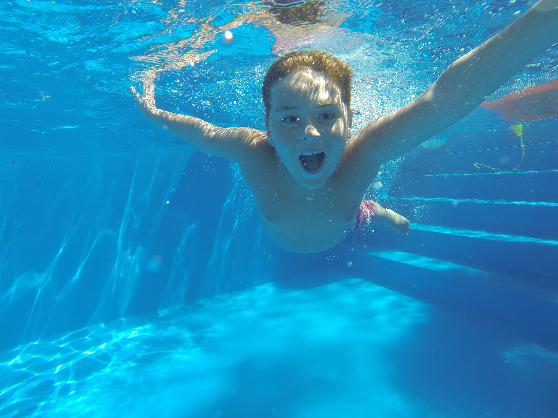 boy swimming in pool