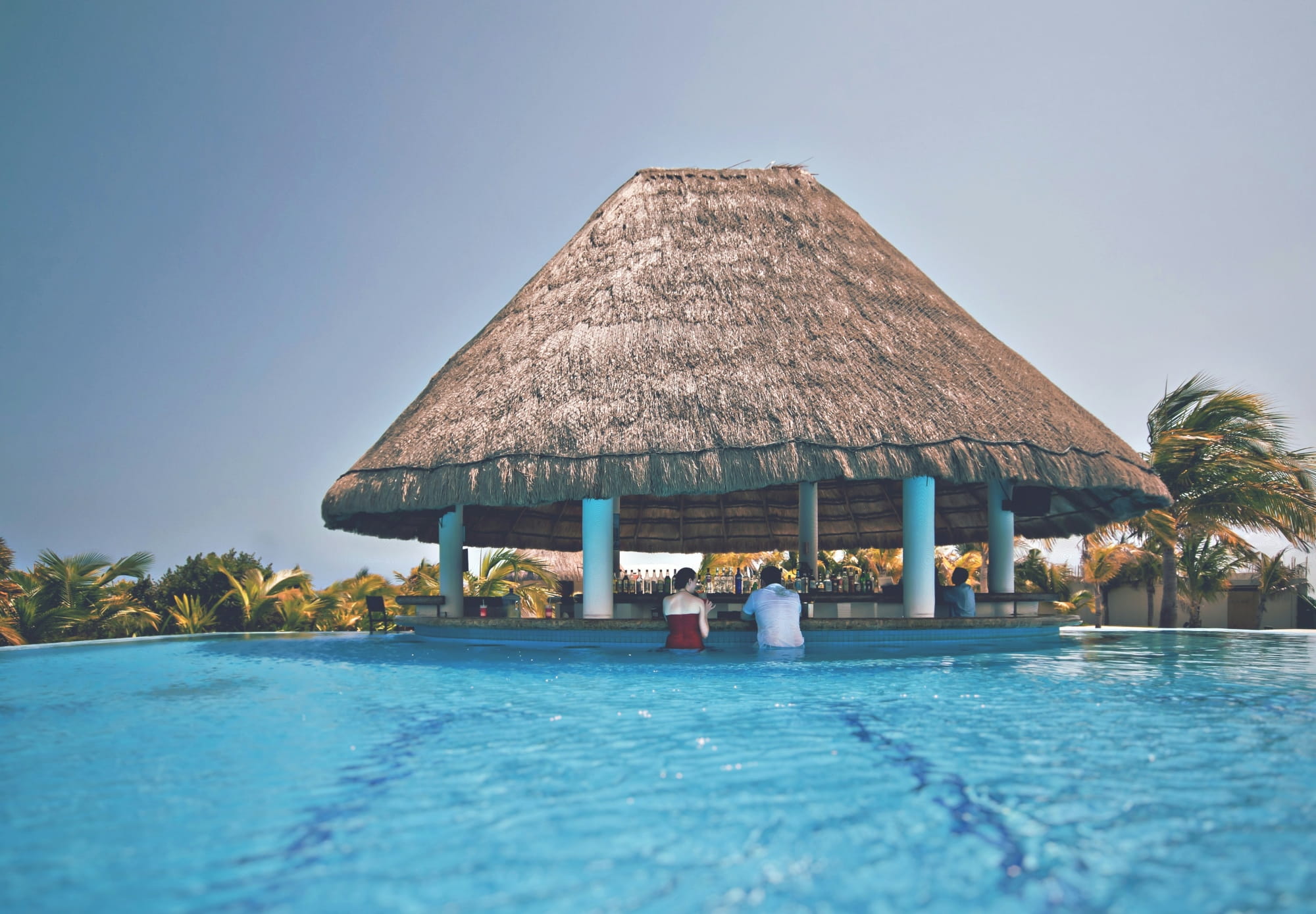 Swim up bar with people.