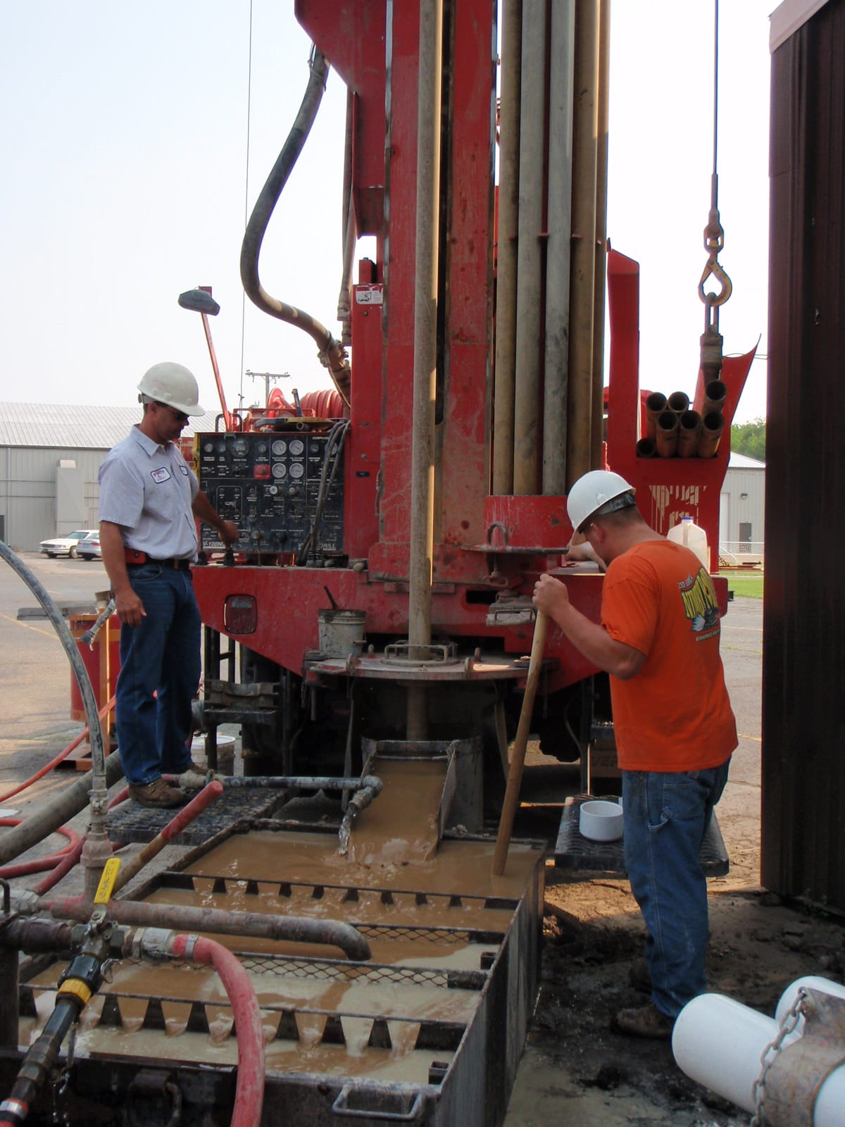 two contractors working on drilling well