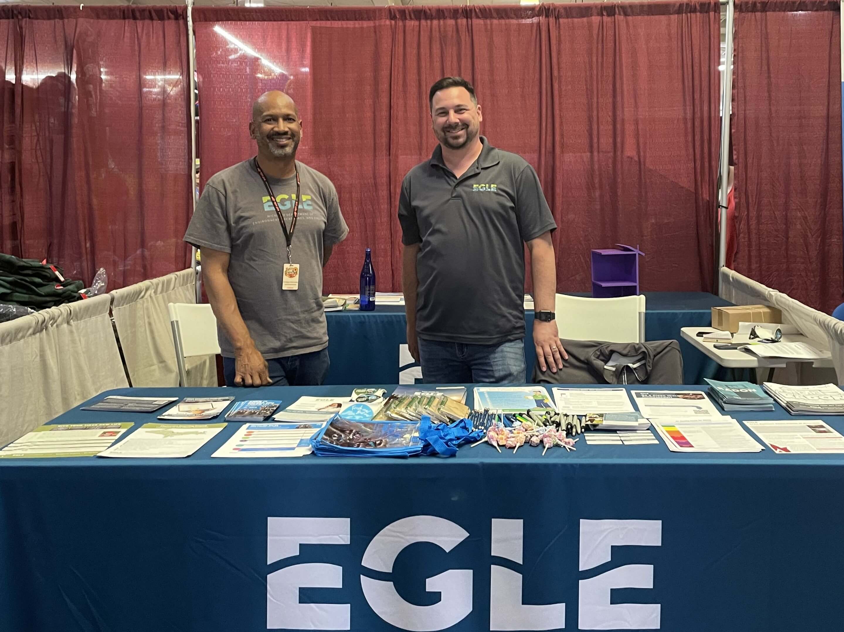 Two EGLE employees at an EGLE informational booth at a public event