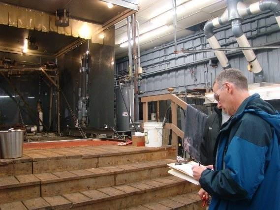 photo of man with clipboard inspecting a facility for compliance