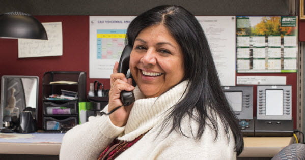 Smiling woman on phone in an office