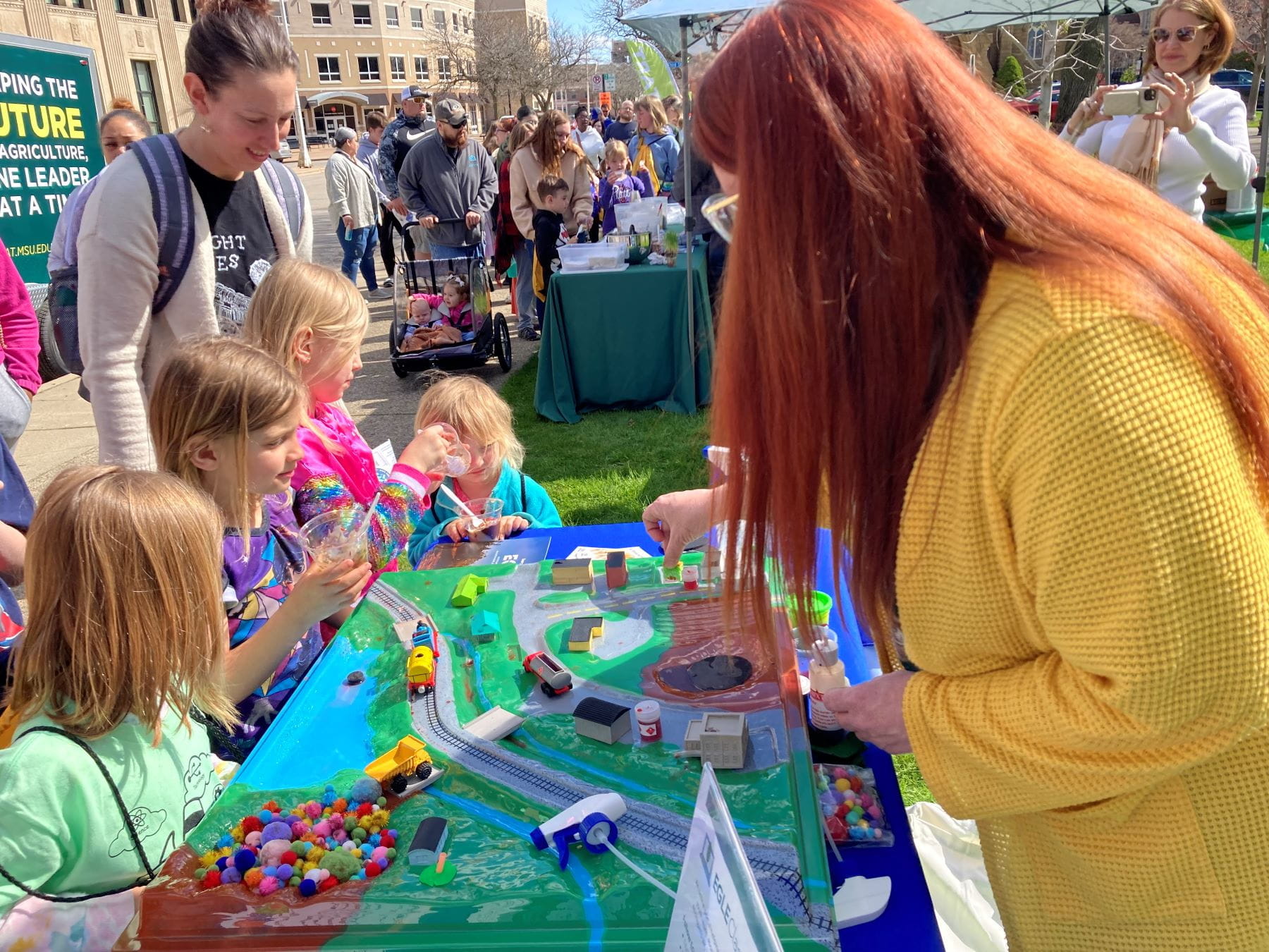 Amanda Daniels, environmental education student assistant, demonstrates the Hazardous Waste Prevention and Cleanup model available through EGLE’s expanded Lending Station program.