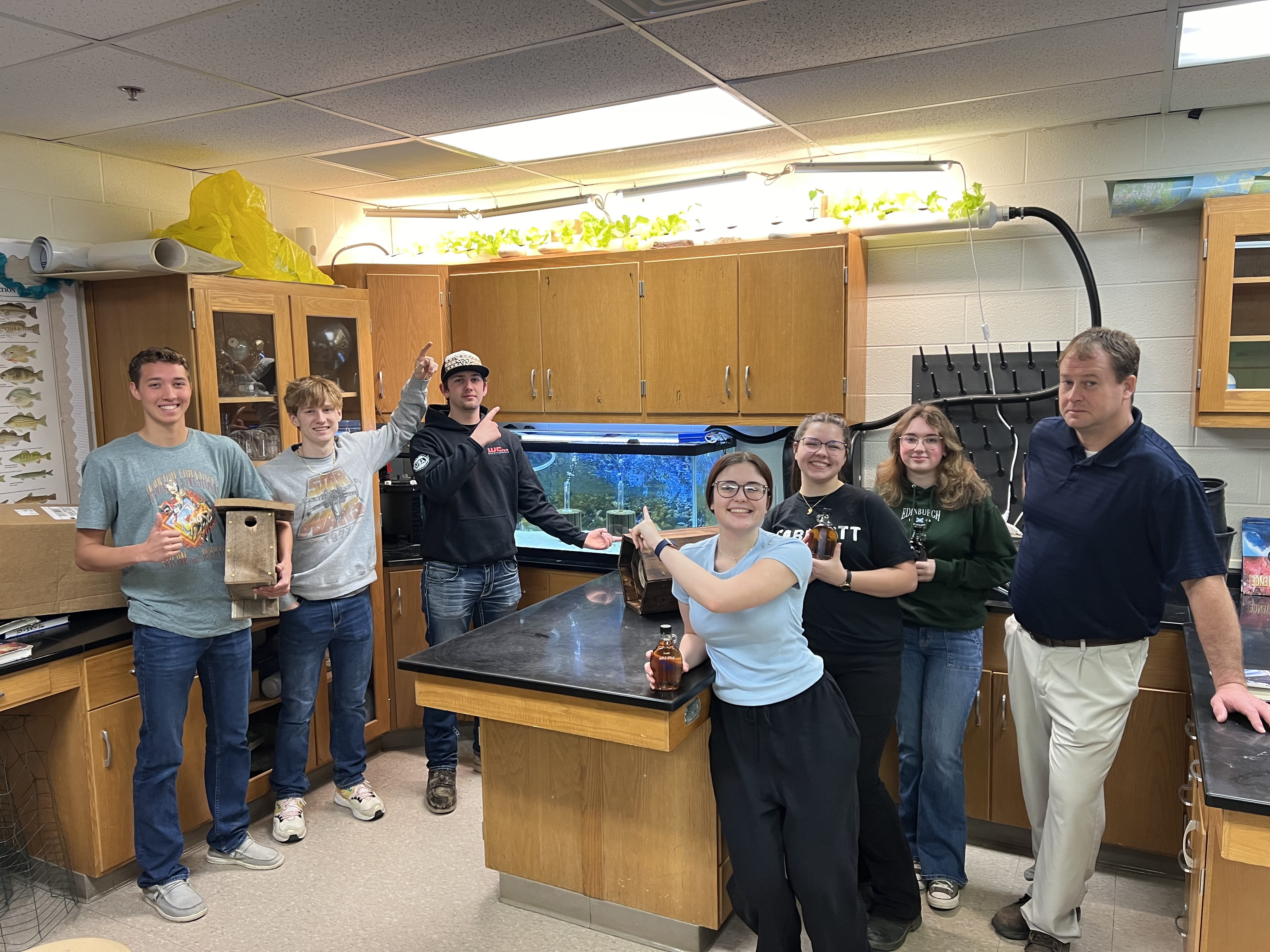 Yale High School students with teacher in front of fish wastewater-aquaponics project that won the Environmental Service Award in 2024.