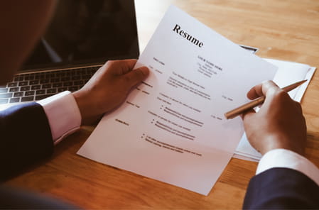 Human Resources person reviewing a resume. 