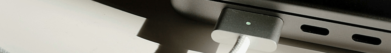 A closeup of a laptop charger plugged into a laptop
