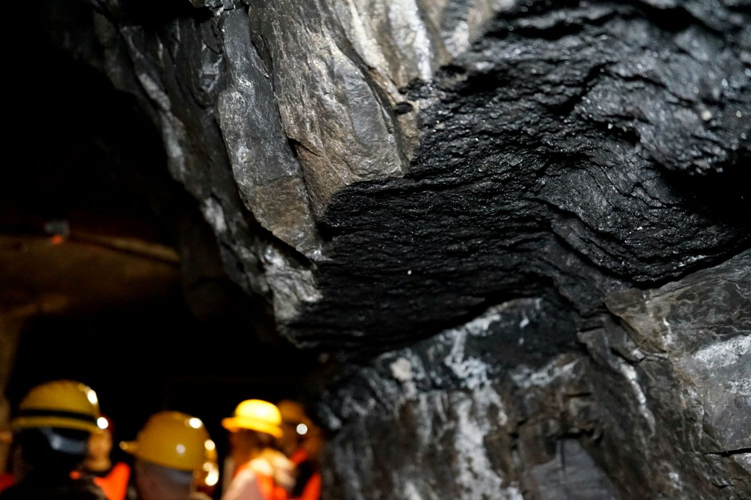 A coal mine with workers wearing hardhats