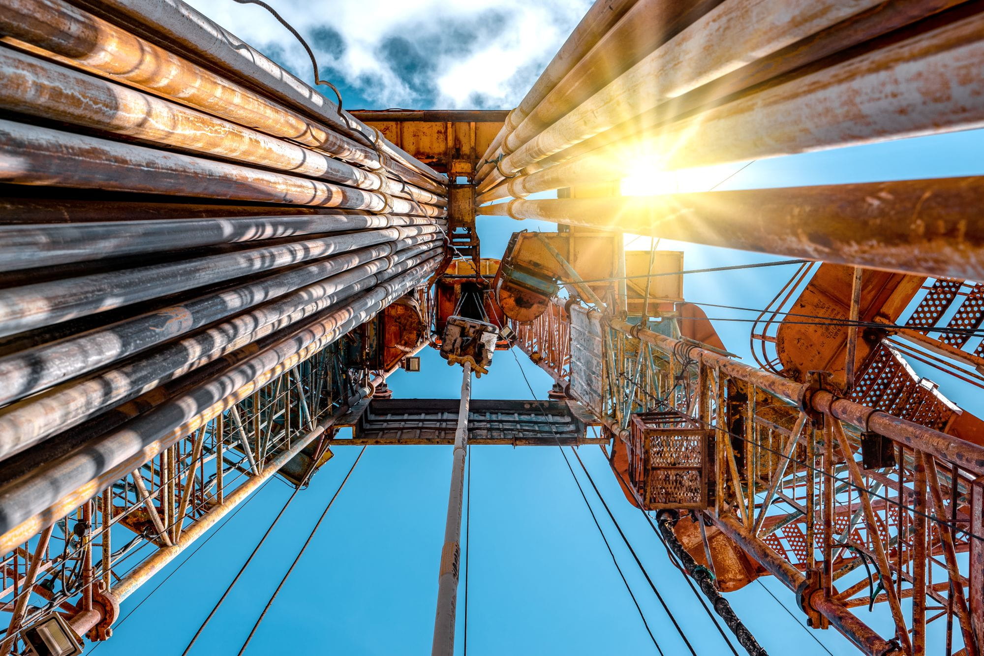 Oil and Gas Drilling Rig onshore dessert with dramatic cloudscape. Oil drilling rig operation on the oil platform in oil and gas industry