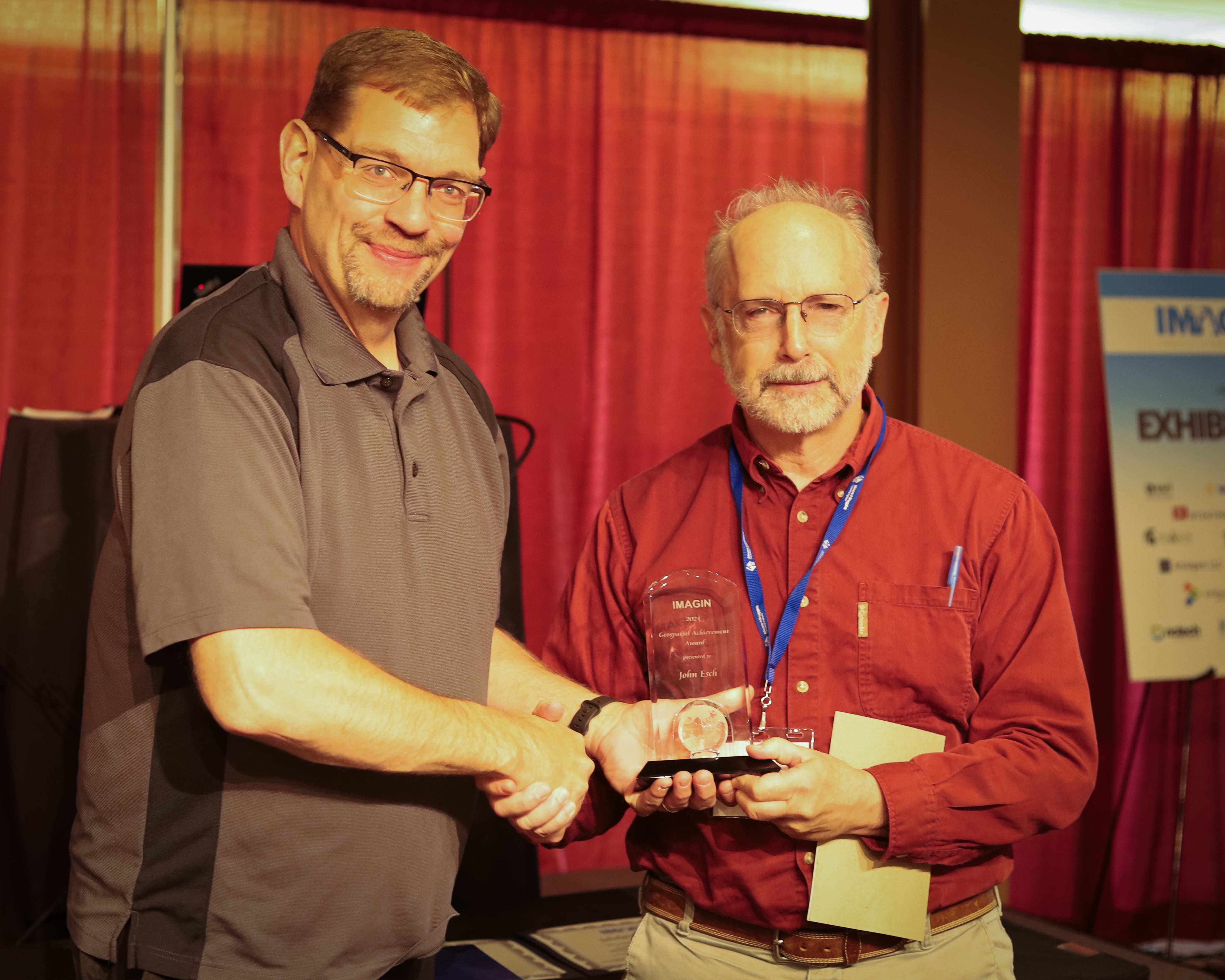 John Esch, EGLE retiree, receives the 2024 IMAGIN Geospatial Achievement award from IMAGIN president Thomas VanBruggen. Esch received the award because of his dedication to advancing the field of geospatial and geologic technology in Michigan. 