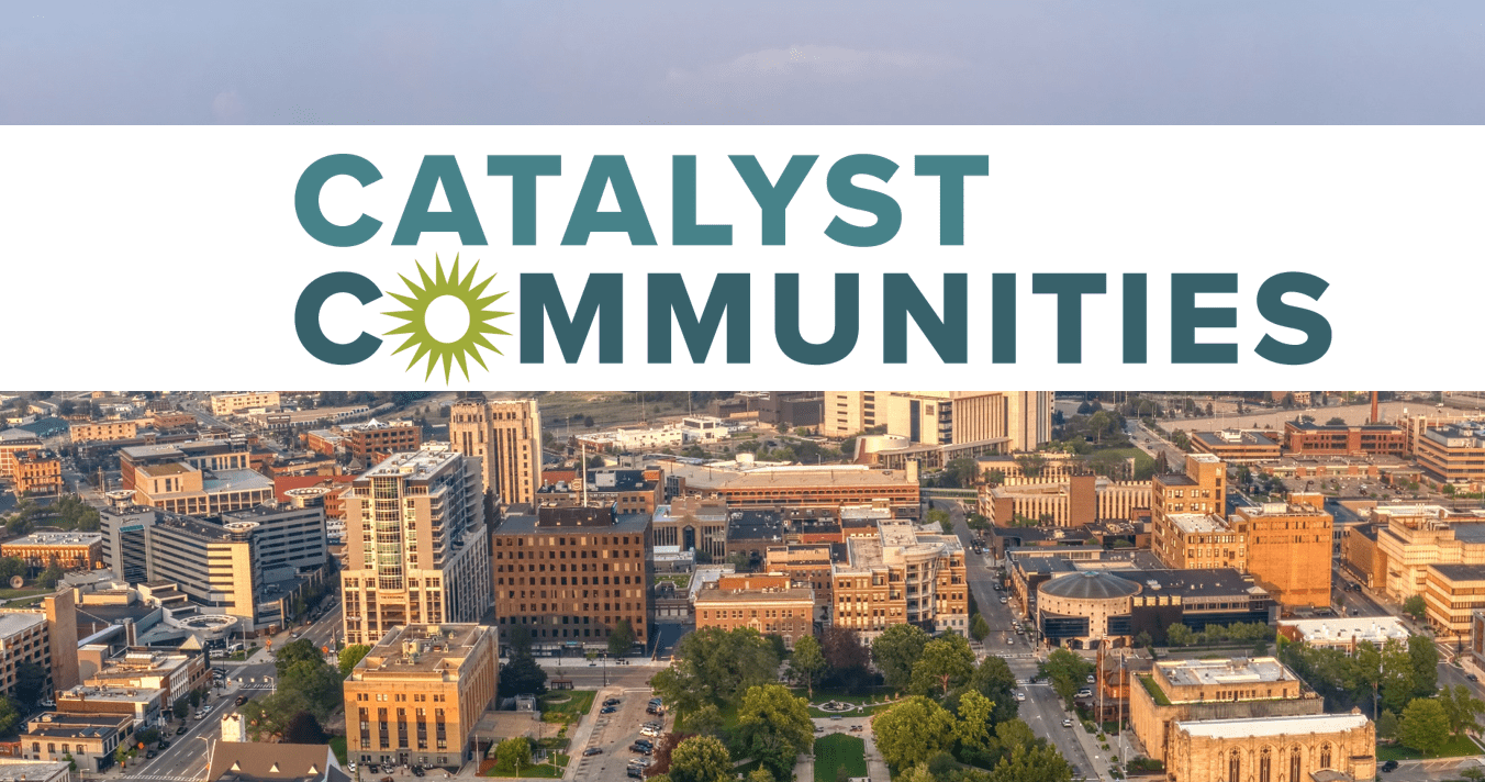 The text Catalyst Communities over an aerial view of Kalamazoo Michigan