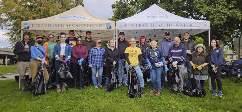 Group of volunteers with trash bags and trash picker uppers