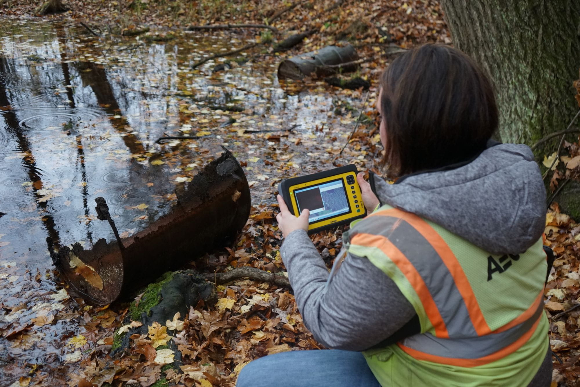 A contractor for the State of Michigan uses a tablet to document potential PFAS contamination. 