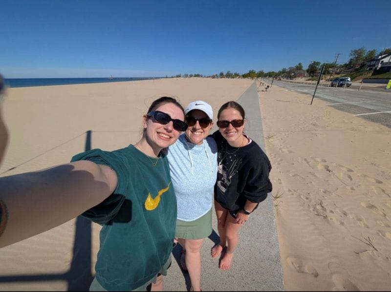 Three people on a beach. 